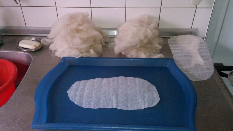 Piles of wool for top and bottom, both molds visible