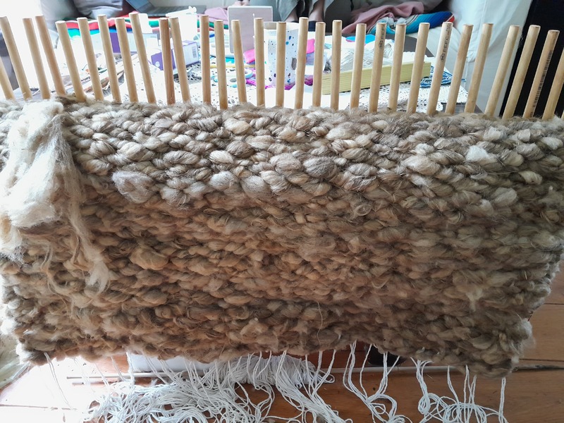 Cream colored mat on peg loom